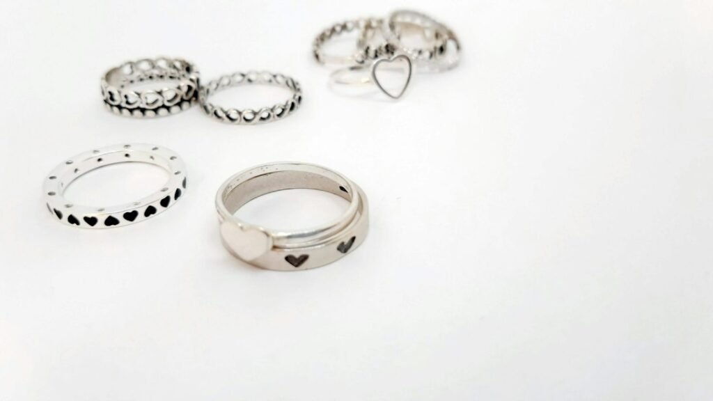 Editorial photograph of silver rings on a light background; illustrative imagery